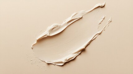 A creamy texture smear on a neutral background, suggesting cosmetic or skincare use.