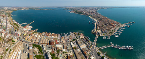 Fototapeta premium Aerial panoramic view of Taranto, one of the most important cities in Puglia, Italy. The Gulf of Taranto overlooks the Ionian Sea.