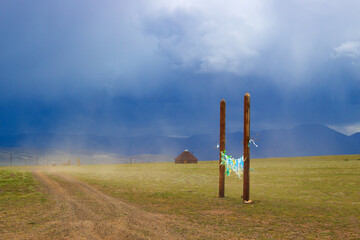 Landscape of the Altai steppe on a stormy day during rain, Russia. Traditional yurt and hitching...