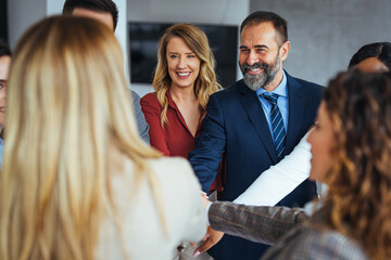 Happy Business Team Celebrating Success with Group Handshake