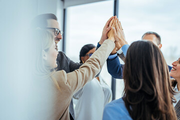 Team Celebrating Success with High Five in Office Environment