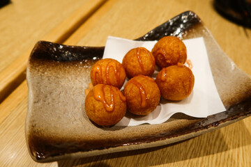close up of six pieces of Japanese deep fried cheese potato ball on a plate
