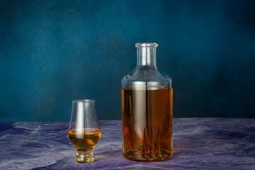 Close-up of a glass and bottle of whiskey.
