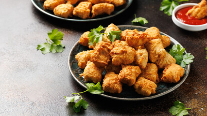 Homemade crispy fried chicken nuggets served with ketchup