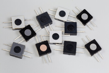 Old electrical flat push button switches on a gray background