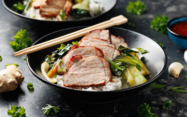 Chinese BBQ Pork Char Siu with rice and bok choy in a black bowl