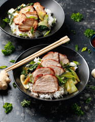 Chinese BBQ Pork Char Siu with rice and bok choy in a black bowl