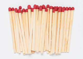 Matchsticks with red tip on white background, close-up top view from above