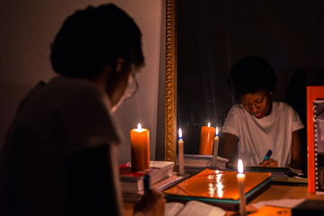 Keep Your Lamps Burning.A young woman holding a candle in the dark