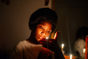 Keep Your Lamps Burning.A young woman holding a candle in the dark
