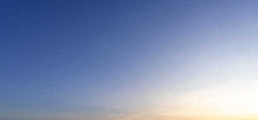 Beautiful morning or evening blue and orange sky while sunsets or sunrises taken at the sea used as natural blackground texture.