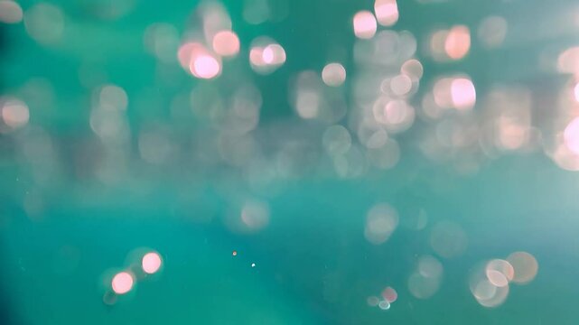 bubbles floating in transparent turquoise clear pool. Multitude of air bubbles rising through clear water