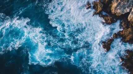 Fototapeta premium Blue ocean waves crashing against rocks, high energy,