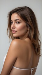 Fototapeta premium Woman in white bikini looking over shoulder