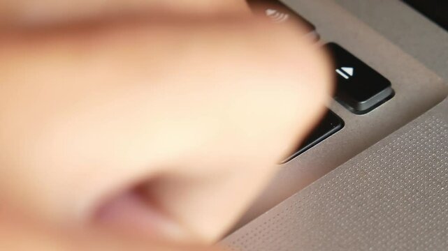 Finger of the computer user, he presses the delete button on the computer keyboard. Push delete button on the keyboard modern laptop.