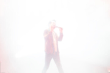 Blurred background rock concert with light background, concert in hall at night. people enjoying music performance in hall. musicians on the stage and spotlights with colored rays. concert and crowd.