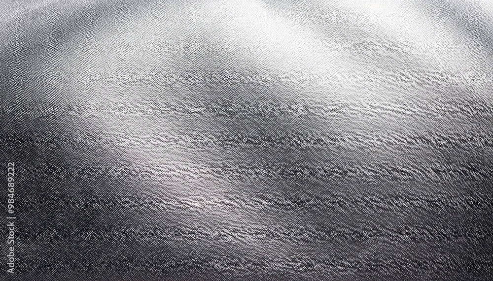 Poster close-up of metallic silver texture with fine granular surface, reflecting light in subtle gradient 