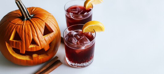 A Halloween-themed cocktail featuring hibiscus and cinnamon set against a white background with a carved pumpkin nearby