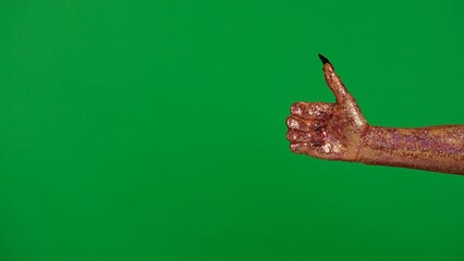 Creepy halloween monster hand in glitter slime with nails waving hand shows thumb up like, isolated on chroma key green screen background, workspace mockup.