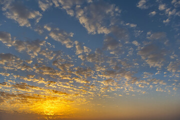 Russia, south of Western Siberia. Panoramic view of the evening sky with the setting sun and colorful clouds.