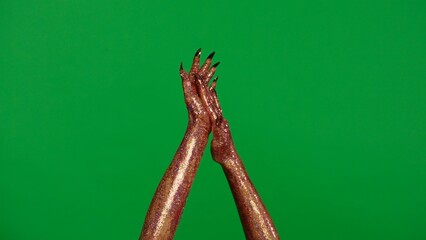 Creepy halloween monster hand in glitter slime with nails shows applause gesture clapping hands isolated on chroma key green screen background, workspace mockup.
