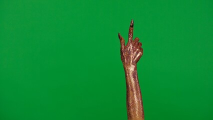 Creepy halloween monster hand in glitter slime with nails pointing finger up, isolated on chroma key green screen background, workspace mockup.