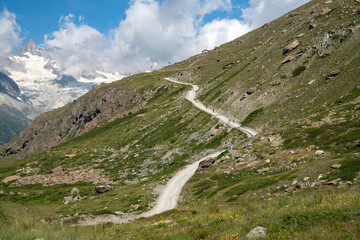 Rocky scenery and very steep trail along the Five Lakes Hike, Matterhorn in view. Zermatt,...