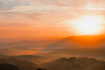 A wonderful view of the sun rays on the mountain at sunrise.