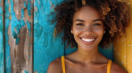 Fototapeta premium Confident American woman standing tall with a bright smile against a vibrant turquoise background.