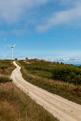 Windmills producing electricity at full capacity with the ocean in the background on La Costa Da Morte in Galicia