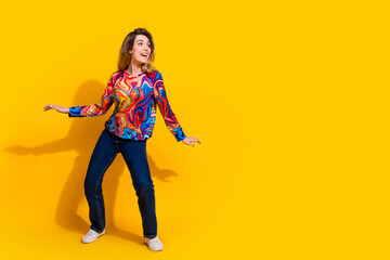 Photo portrait of young funny blonde hair adorable woman wearing bright shirt and dancing isolated on yellow color background