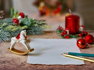 White paper ready to fill in your Christmas wish list. Christmas decorations around.
