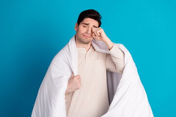 Photo of attractive young man rub eye tired wrapped duvet dressed pajama sleepover good night...