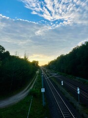 Empty railway in the countryside, beautiful cloudy sky