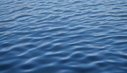 Gentle rippling blue water surface in a serene environment with calm waves and copy space
