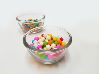 Multicolored sweet candies in a glass bowls on white background. colorful confectionery treats for birthdays
