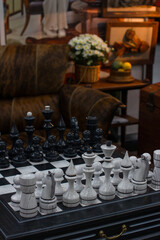 a chess table with pieces. Cozy home interior, board games