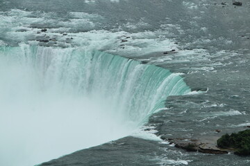An awe-inspiring view of Niagara Falls captured from above, revealing the raw power of the...