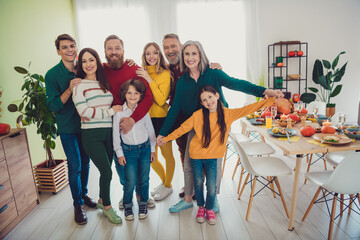 Full length photo of big family celebrate holiday dinner hugging have fun multi-generation...