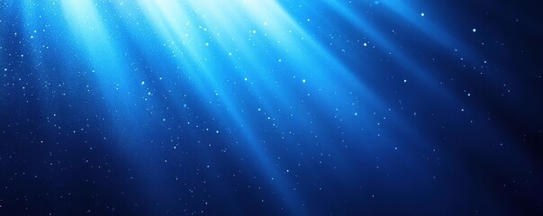 Obraz premium A serene underwater scene showcasing vibrant blue light rays penetrating the surface, creating a tranquil atmosphere.
