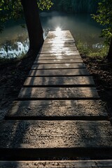 Fototapeta premium A serene scene featuring a wooden dock stretching into a tranquil lake, with the setting sun casting gentle shadows on the water.