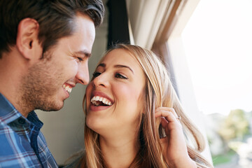 Home, love and couple with affection, laughing and bonding of people, relationship and romance in morning. House, man and woman in weekend, hug and fun in marriage, together and happy with embrace