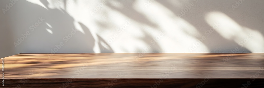 Poster abstract shadow pattern on wooden surface. sunlight through leaves overlay on a tabletop with copy s
