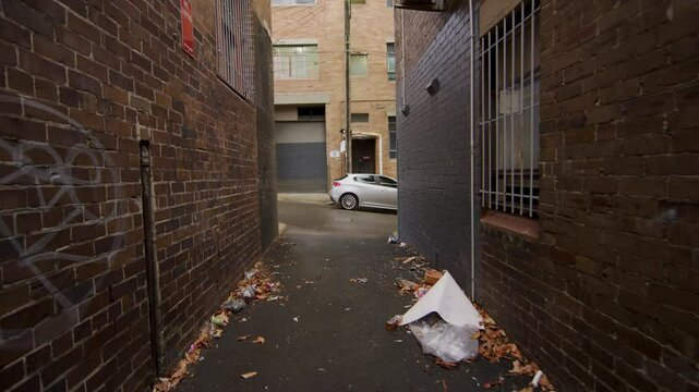 Slow point of view moment through narrow brick alleyway