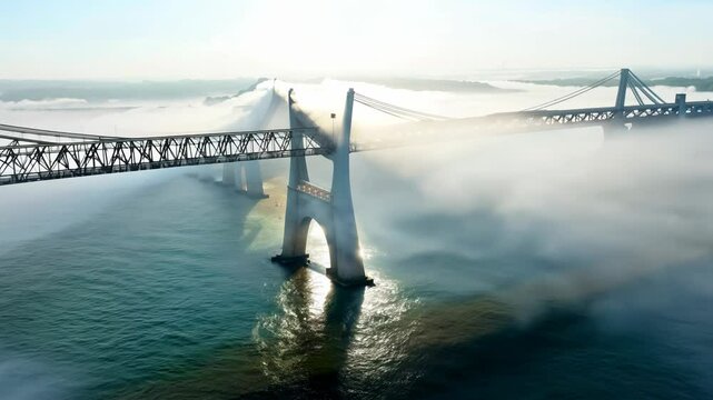 Bridge over the river in morning fog. Abstract suspension bridge on natural landscape with aerial view