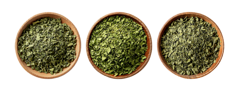 Dried Lovage fills three wooden bowls, its vibrant green color and unique aroma promising to add depth and complexity to dishes