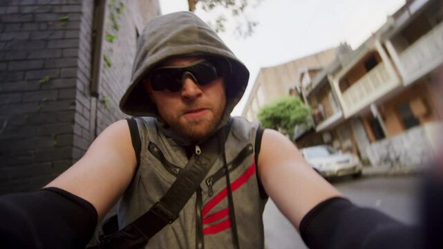 Hooded man jumping from behind corner and grabbing camera - point of view