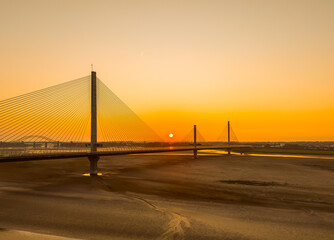 Liverpool, Merseyside, UK, September 18, 2024; aerial view of the Mersey Gateway toll bridge with stunning sun set over the River Mersey, Liverpool, UK.