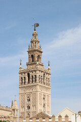 The giralda, bell tower of seville cathedral standing tall under blue sky-