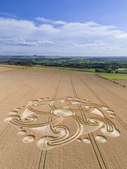 Aerial view of an intricate geometric crop circle formation in a wheat field near Etchilhampton and Devizes in Wiltshire, England, UK